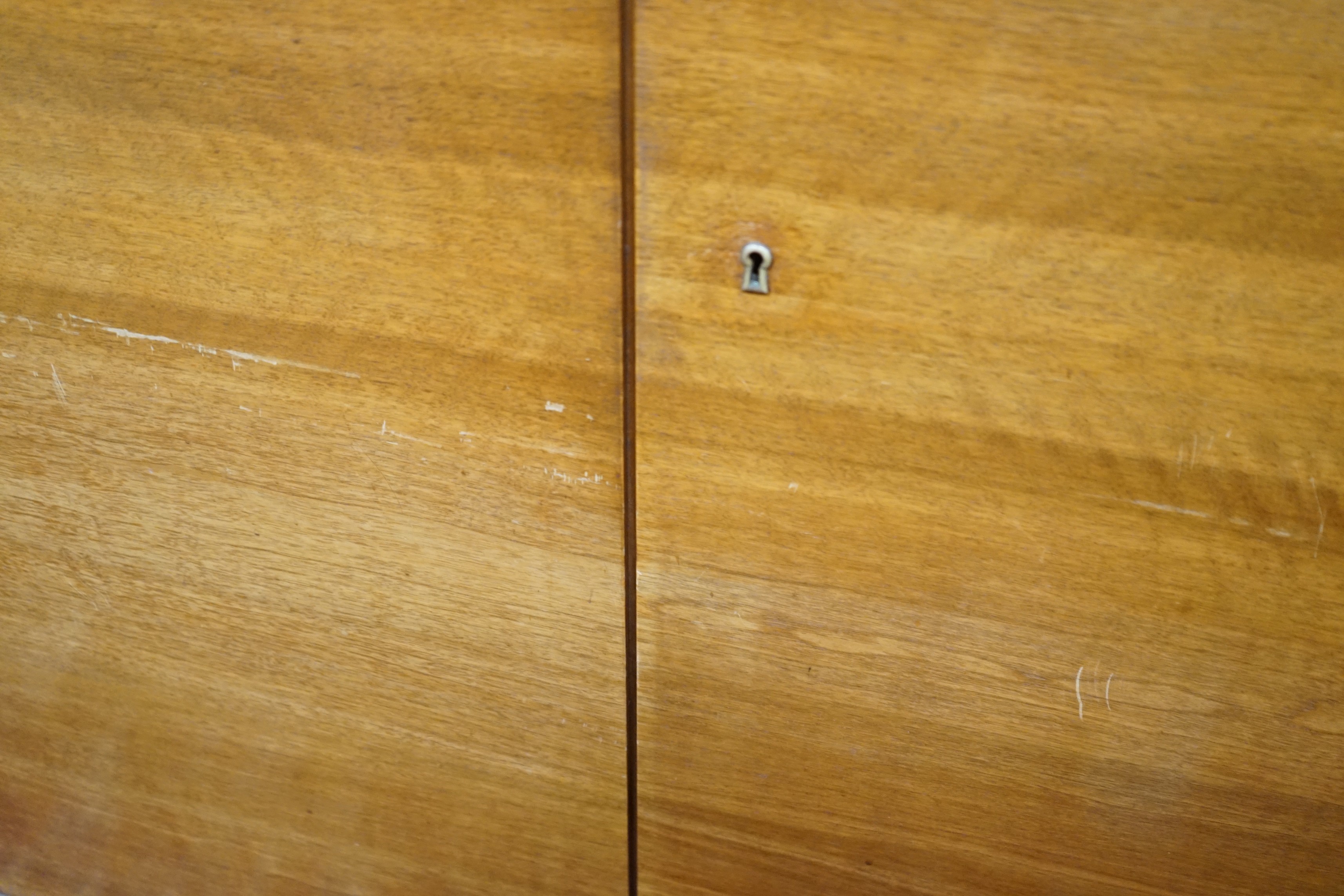 A mid century walnut two door cabinet, by Georg Schoettle, Stuttgart, width 135cm, depth 40cm, height 160cm